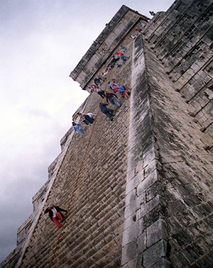 People struggle to climb the very steep steps of El Castillo, Chichen Itza, Yucatán Peninsula, Mexico
