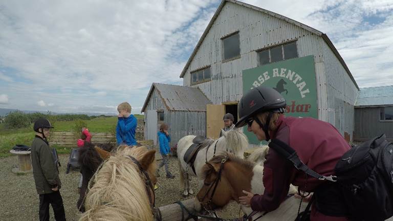 A group of people sitting on a horse