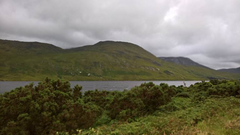 A body of water with a mountain in the background

Description generated with very high confidence