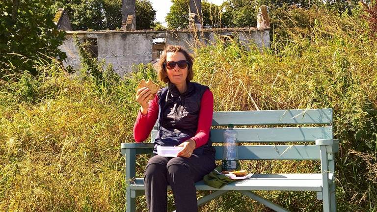 A person sitting on a park bench. Description generated with very high confidence
