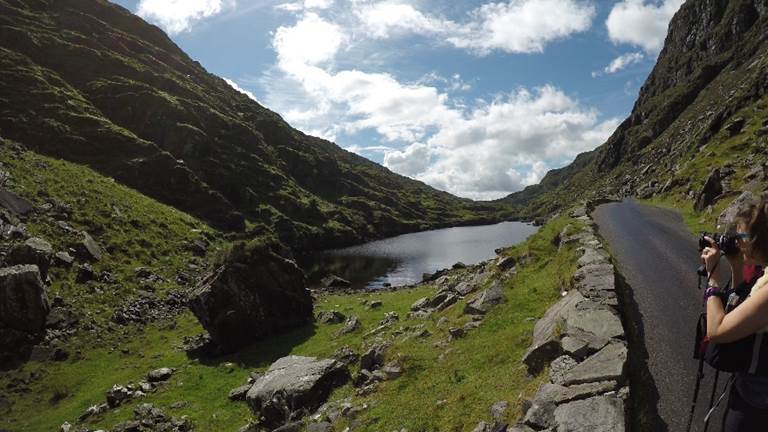 A person standing on a rocky hill