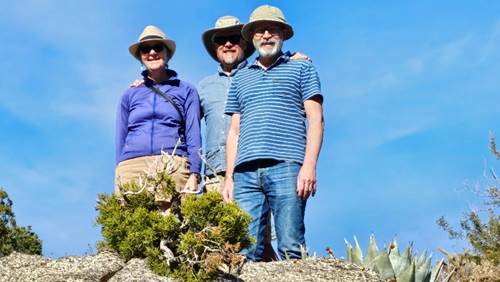 A group of people standing on a rock