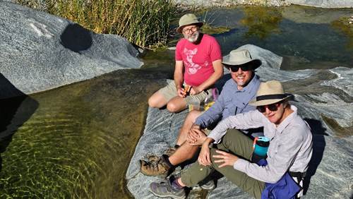 Friends relaxing by water in Palm Springs